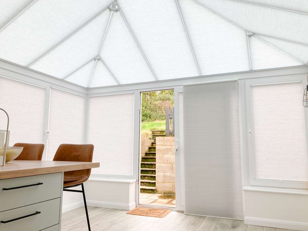 Duette® Free-hanging blinds on a sliding door in a conservatory